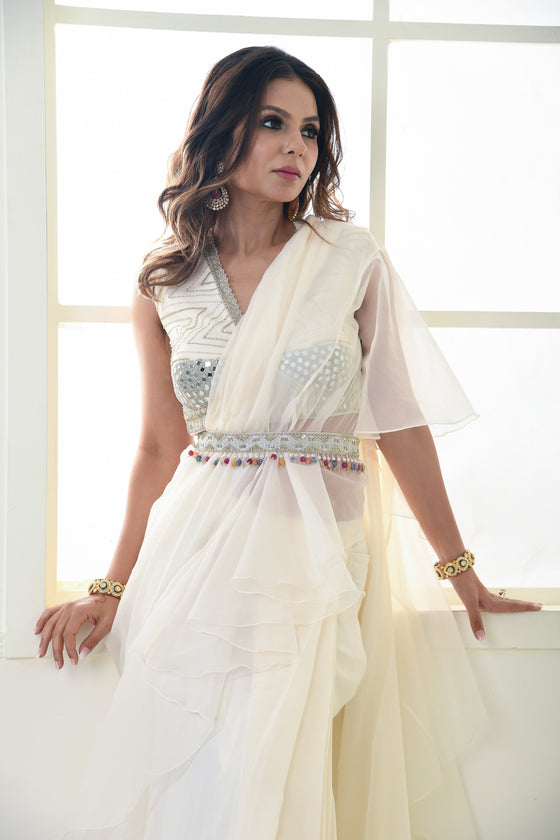 Embroidered drape saree with organza ruffles and sexy sleeveless blouse.