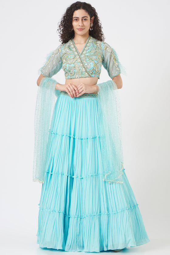 Stylised blouse with dreamy fin sleeve teamed with tiered lehenga and mesh dupatta