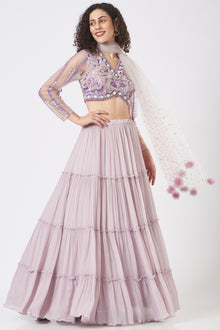  Stylised blouse with dreamy fin sleeve teamed with tiered lehenga and mesh dupatta