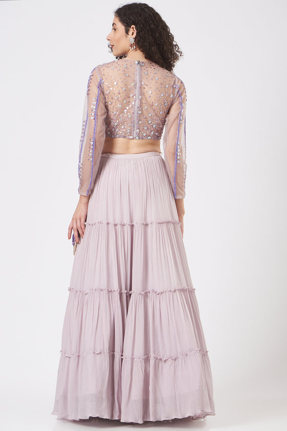 Stylised blouse with dreamy fin sleeve teamed with tiered lehenga and mesh dupatta